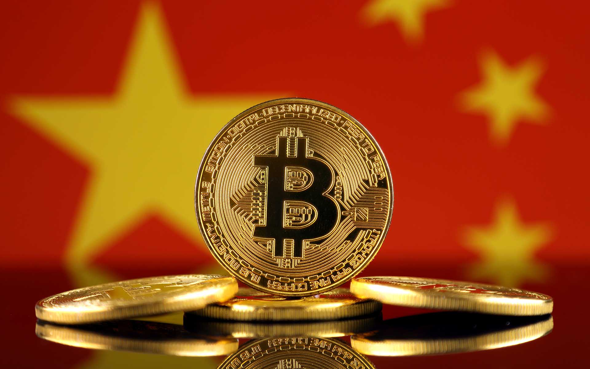 A standing bitcoin in front of the China flag