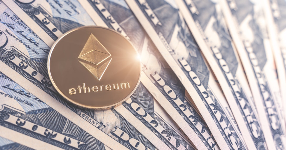 Ethereum coin sitting on top of dollar notes