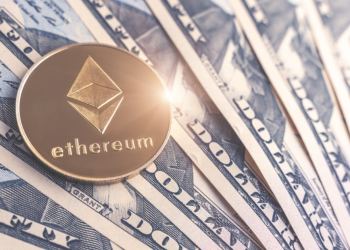Ethereum coin sitting on top of dollar notes
