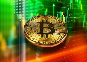 Picture of a bitcoin in front of green charts with red on the bottom