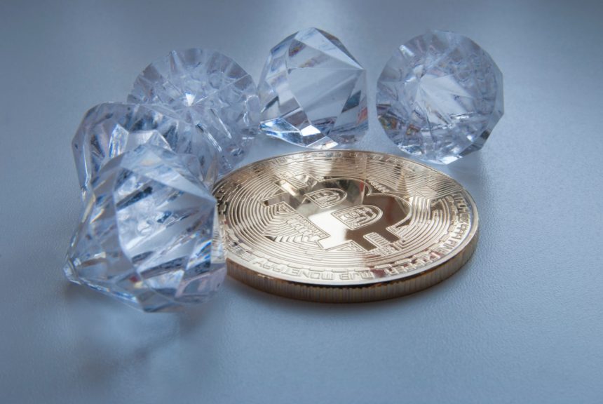 Picture of a bitcoin with five diamonds around it
