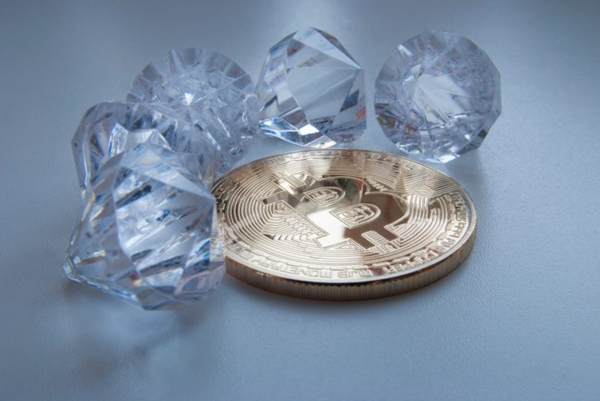 Picture of a bitcoin with five diamonds around it