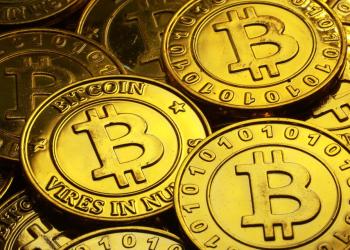 Gold bitcoin stacked on top each other