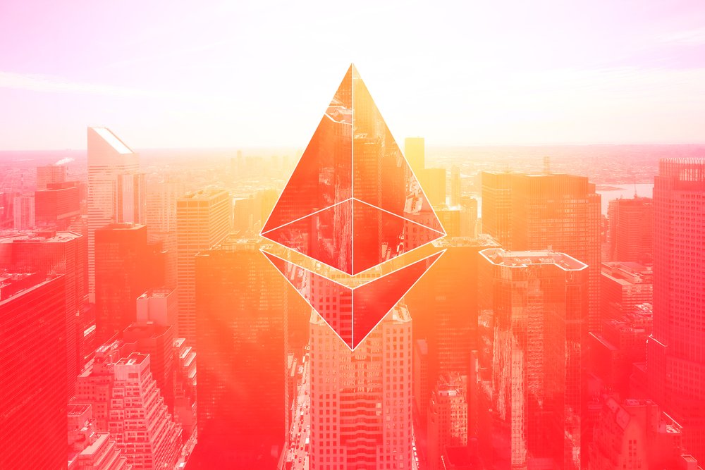 Picture of an ethereum symbol above a city with a red hue