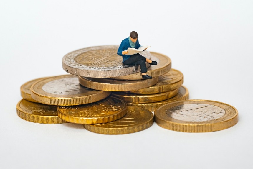 Capital International, a toy mini person over coins