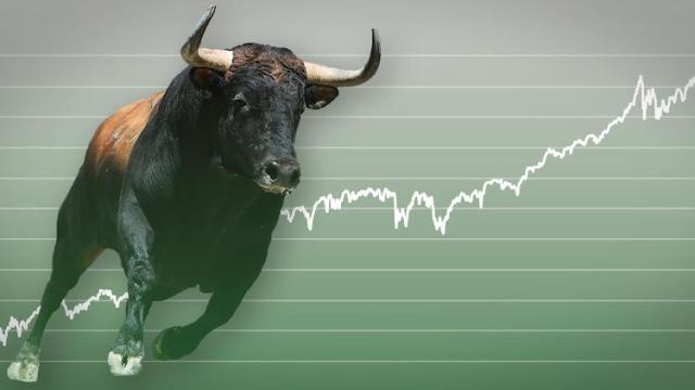 picture of a bull on a green upward chart