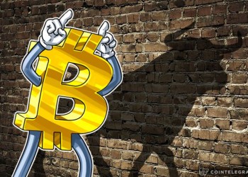 picture of a bitcoin with two fingers on its head, casting the shadow of a bull on the wall