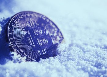 Picture of a bitcoin with snow surrounding it