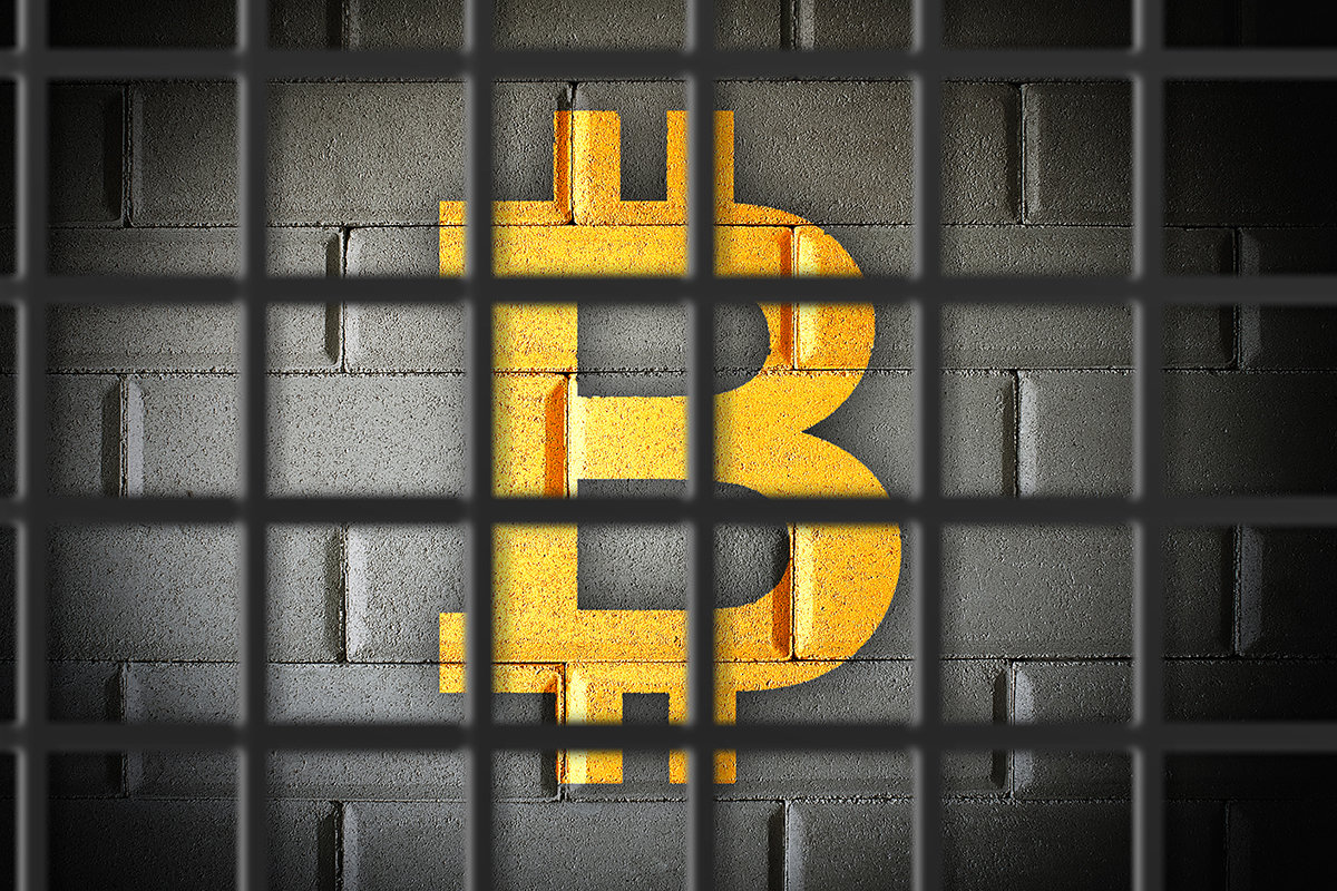 picture of a bitcoin locked behind prison bars
