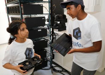 Siblings Ishaan and Aanya Thakur holding mining equipment