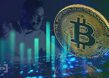 Picture of a slightly slanted gold bitcoin in front of a candlestick chart