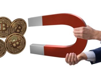 Picture of a hand attracting four gold bitcoin crypto coins with a giant red and white magnet