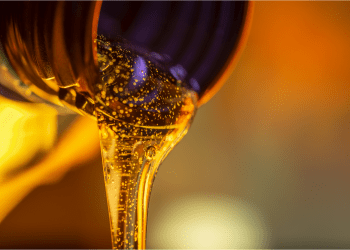 Picture of a gold liquid being poured out of a bottle, representing liquidations