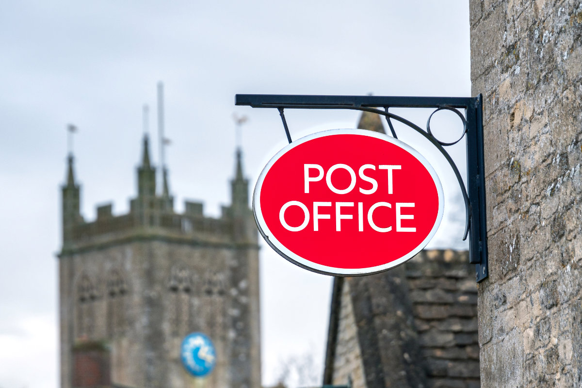 Picture of a red and white Post Office sign