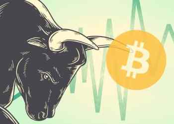 Picture of a bull with its horns pointed at a bitcoin