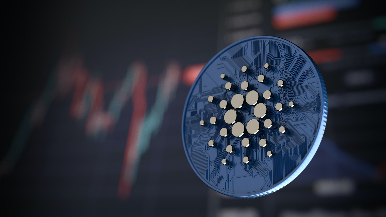 Picture of a Cardano coin in front of a market chart