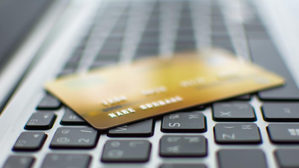Picture of a gold debit card on a computer keyboard, depicting COTI debit cards