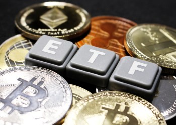 Picture of Scrabble tiles spelling ETF with bitcoins around it