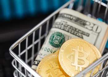 Picture of two bitcoins in a cart with a folded $20 bill