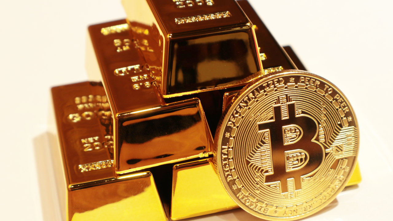 Bitcoin in front of gold bars