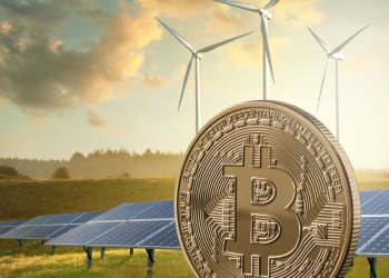 Picture of a Bitcoin with wind vanes and solan panels behind it