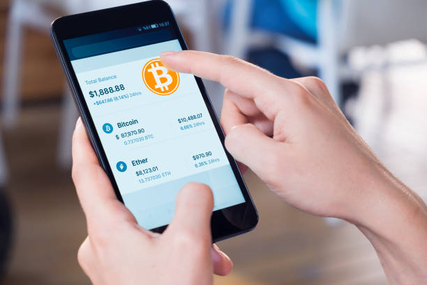 Picture of a hand holding a phone with a bitcoin wallet on it
