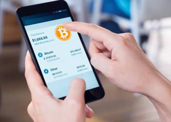 Picture of a hand holding a phone with a bitcoin wallet on it