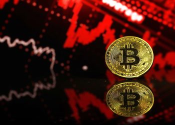Picture of a bitcoin with a red chart behind it