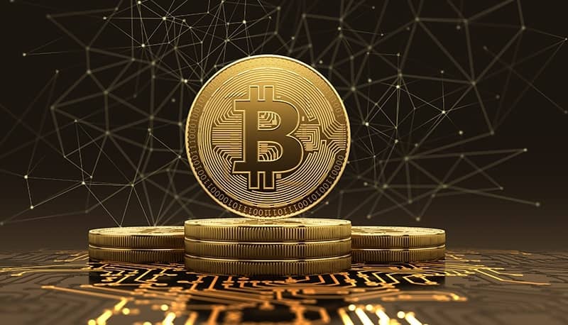 A bitcoin standing on other coins