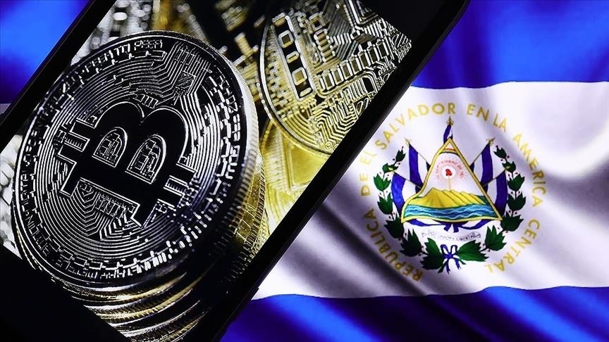 Picture of a bitcoin on top an El Salvador flag