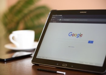 Google on a tablet with a coffee in the background