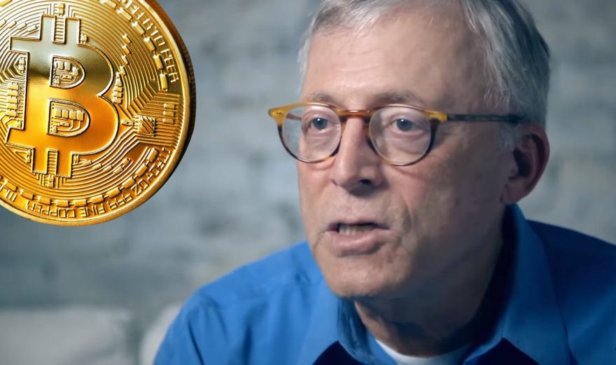 Steve Hanke with a bitcoin next to him