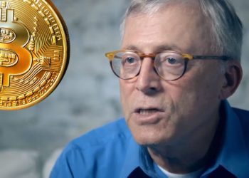 Steve Hanke with a bitcoin next to him