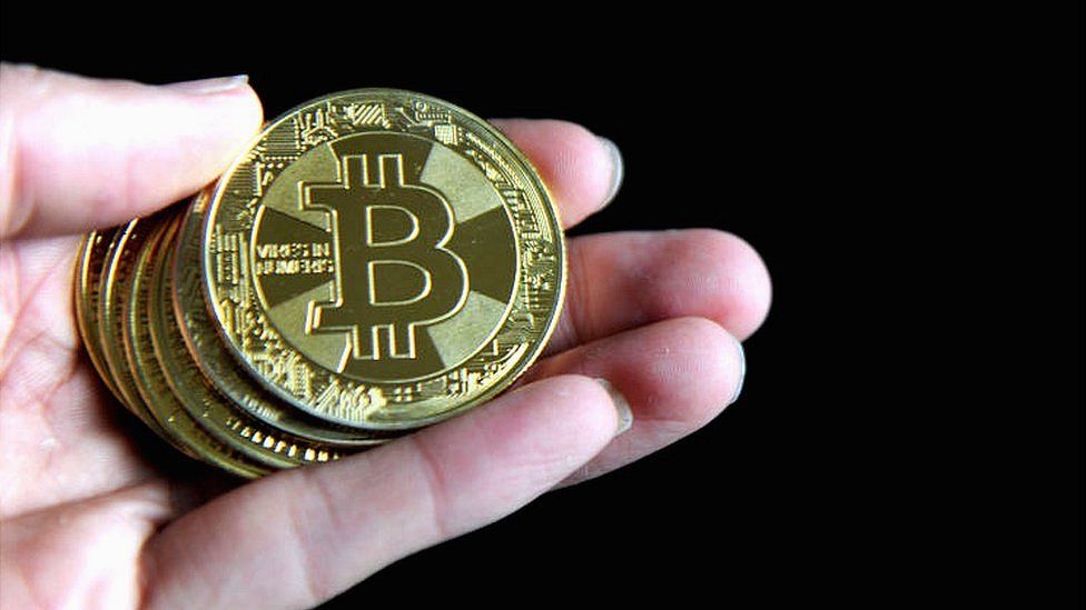Handing holding bitcoins