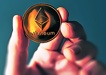 Hand holding Ethereum coin