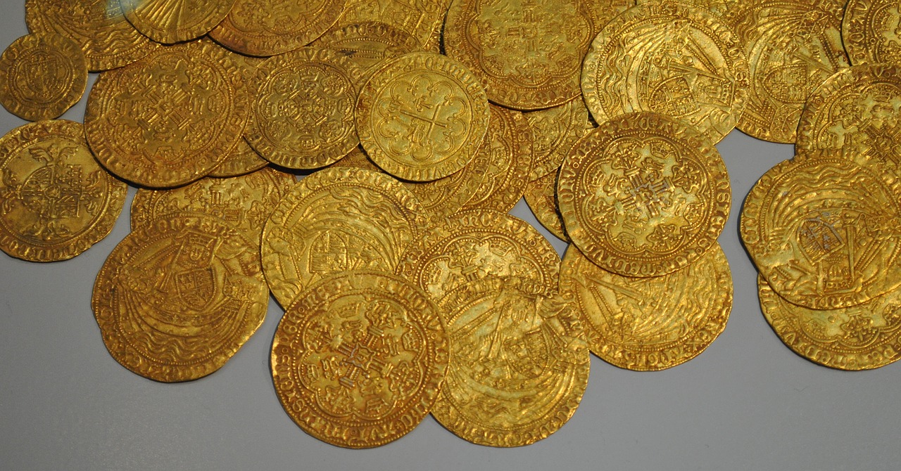 Zimbabwe, gold coins over grey background