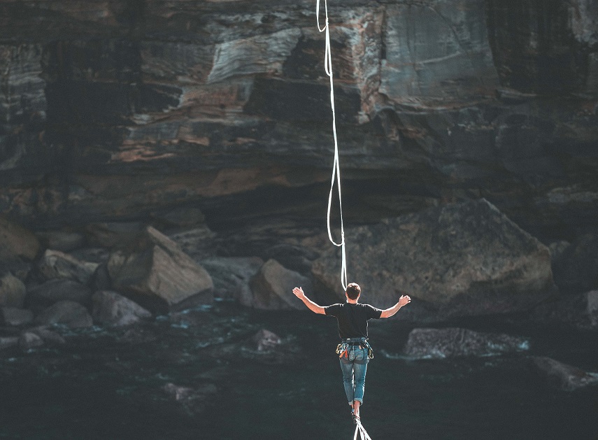 Merge, a man over a tight rope
