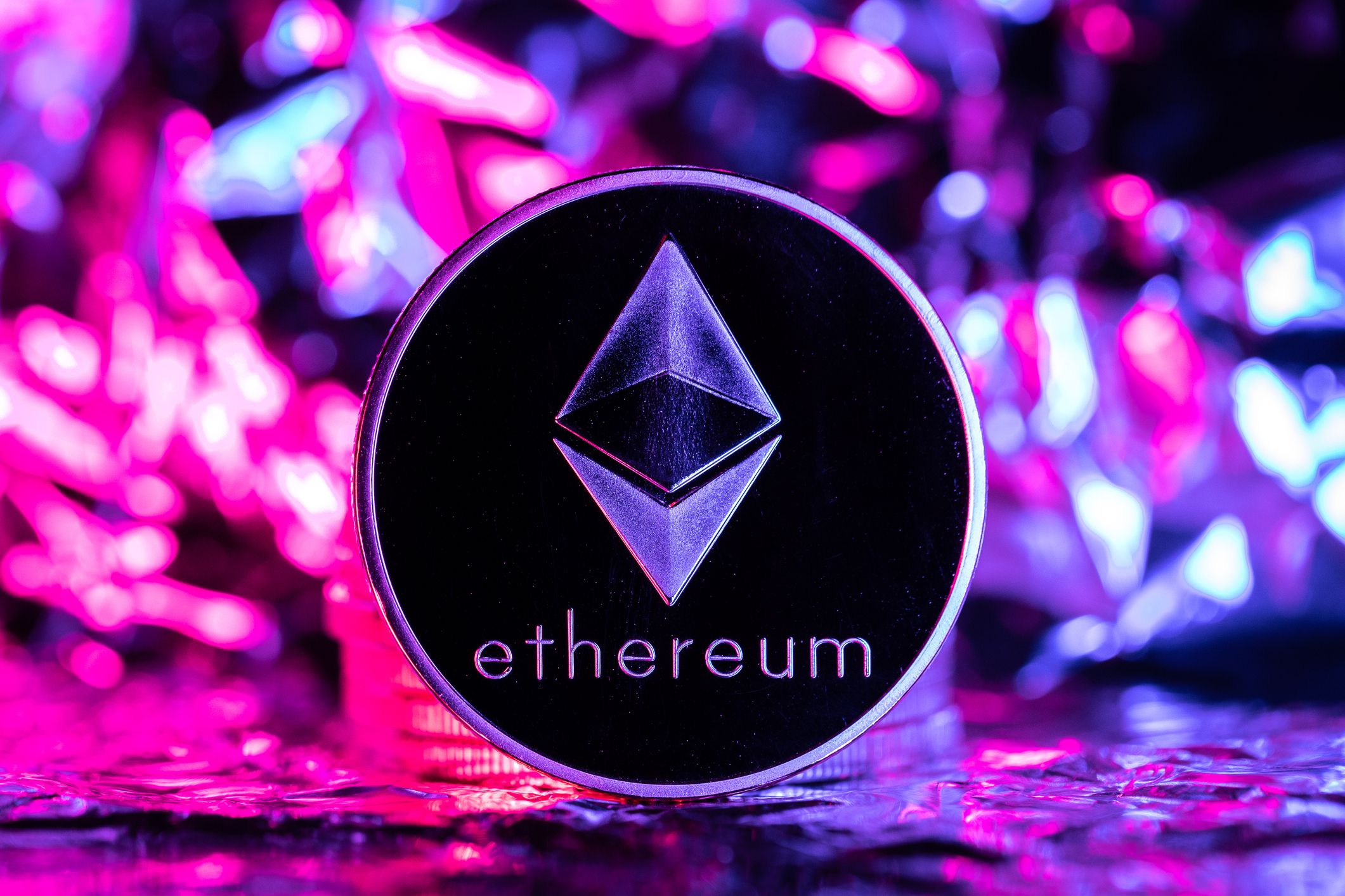 Ethereum Arbitrum Optimism Deneb hard fork, physical coin in front of an abstract background